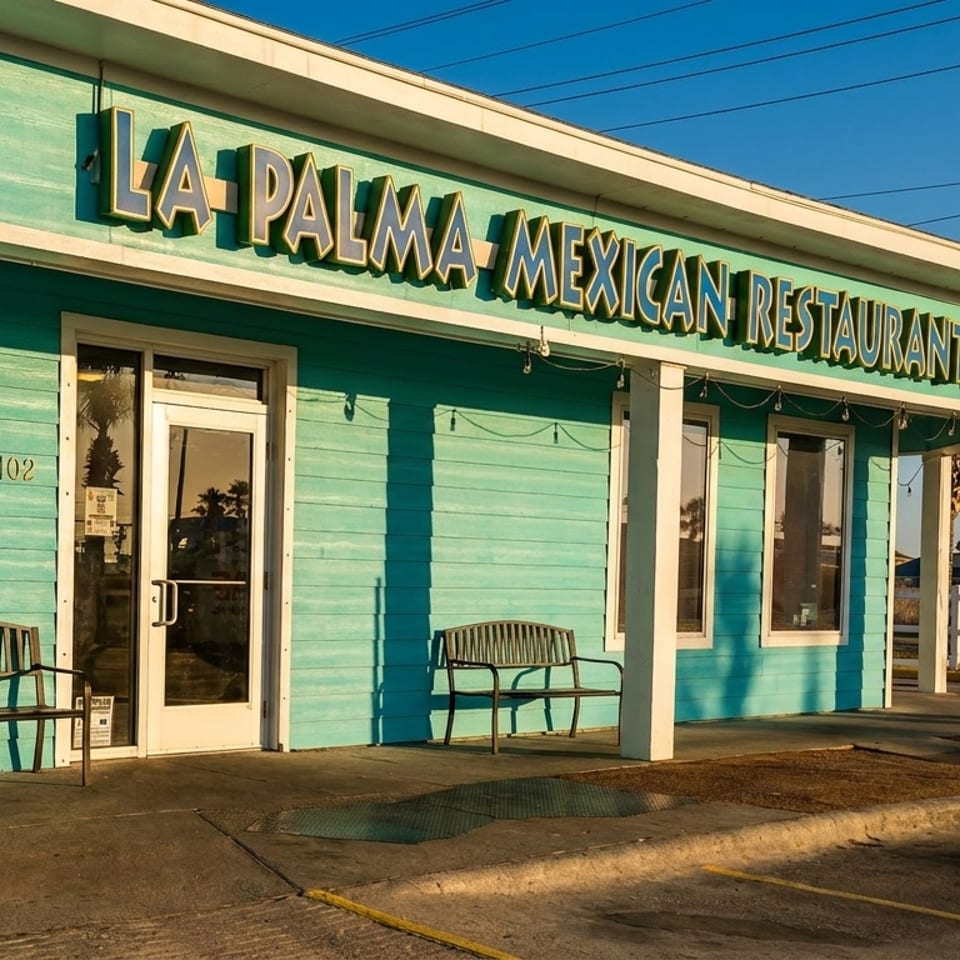 Turquoise La Palma Mexican Restaurant #2 storefront with benches, palm trees, and a sunny roadside setting.